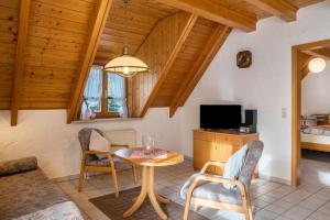a living room with a table and chairs at Gasthaus Zur Linde- Napf in Oberried