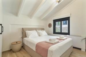a bedroom with a bed with two towels on it at Mella Roa - Villa Onyx in Nydri +18 photos