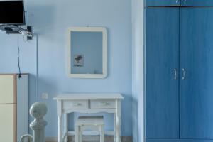 a blue room with a table and a blue wall at Giorgio studios-apartments 2 in Nikiana