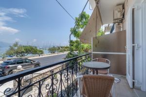 a balcony with a table and a view of a street at Giorgio studios-apartments 2 in Nikiana