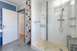 a shower with a glass door in a bathroom at Maison Ty Gwen in Le Pouliguen +17 photos