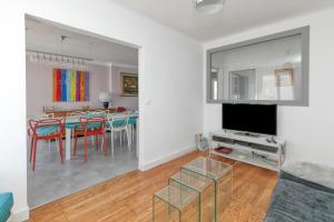 a living room and dining room with a table and chairs at Maison Ty Gwen in Le Pouliguen