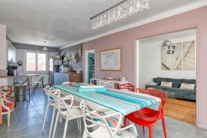 a kitchen and living room with a table and chairs at Maison Ty Gwen in Le Pouliguen