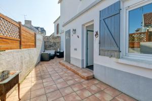 a patio with a door and a window at Maison Ty Gwen in Le Pouliguen