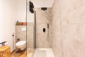 a bathroom with a toilet and a glass shower at A Casa Assulanata Cinto in Santa-Reparata-di-Balagna +12 photos