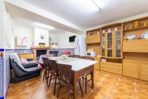 a kitchen with wooden cabinets and a table and chairs at Casa rural Mccoy 2 in Macael