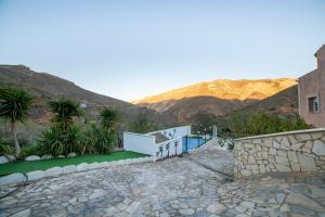 a house with a mountain in the background at Casa rural Mccoy 2 in Macael
