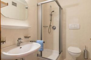 a bathroom with a sink and a shower at Taufner Apartement A 105 in Parcines +22 photos