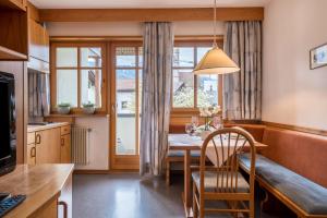 a kitchen and dining room with a table and a window at Taufner Apartement A 105 in Parcines
