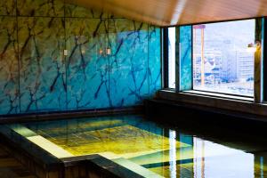 a room with a glass floor in a building with a window at Hotel Sekitei in Fuefuki