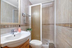 a bathroom with a sink and a toilet and a shower at Casa Essência in Armação de Pêra +15 photos