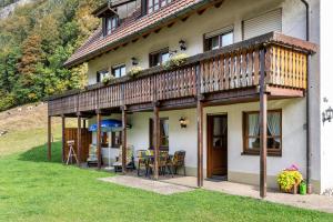 a house with a deck and a table and chairs at Gasthaus Zur Linde- Napf in Oberried