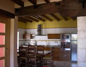 a kitchen with a table and some chairs in it at Bordaberri in Ciáurriz
