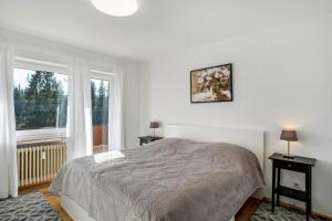 a white bedroom with a bed and a window at Ferienwohnungen Nordschwarzwald in Freudenstadt +26 photos
