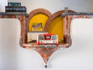 a small red truck sitting on a mirror at Le Cocon in Villalier