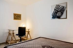 a bedroom with a desk and a chair and a picture at Le Cocon in Villalier