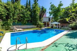 a swimming pool in the backyard of a house at Villa La bicicleta azul in Málaga