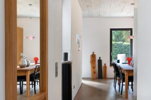 a kitchen and dining room with a table and a refrigerator at Schicke neue Ferienwohnung, Meppen in Meppen +17 photos