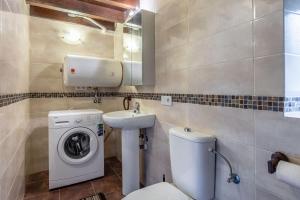 a bathroom with a washing machine and a sink at La Plazuca Cerrucao in Selaya +24 photos