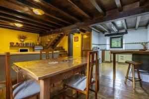 a large kitchen with a wooden table and chairs at La Plazuca Cerrucao in Selaya