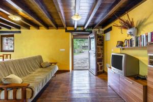 a living room with a couch and a tv at La Plazuca Cerrucao in Selaya
