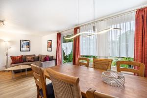 a dining room with a table and a couch at Bungalow 71 in Zeulenroda