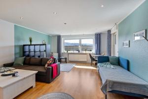a living room with a couch and a table at Ferienwohnung Sterl 13 in Herscheid
