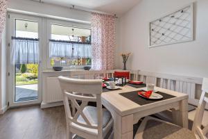 a kitchen and dining room with a table and chairs at Ferienwohnung Sterl 13 in Herscheid +19 photos
