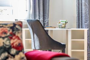a chair sitting next to a table with a desk at Ferienwohnung Sterl 13 in Herscheid