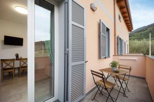 a room with a balcony with a table and chairs at Antichi Ricordi - Da Angela in Marina di Andora