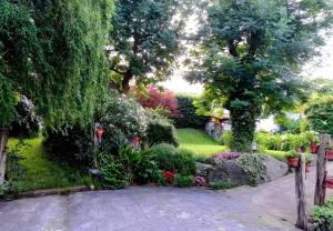 a garden with flowers and trees and a path at Lokate 2 Habitaciones in Aia +6 photos