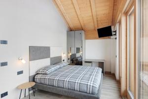 a bedroom with a bed and a television in it at Plaz in Livigno