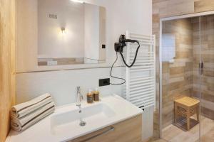 a bathroom with a sink and a shower at Plaz in Livigno +16 photos