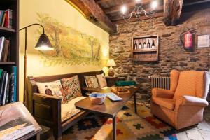 a living room with a couch and a table at Casa Rural Casa Mario in Cangas del Narcea