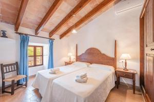 a bedroom with two beds in a room at Can Faveta in Alcudia +20 photos
