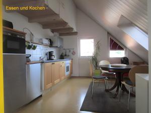 a kitchen with a table and a dining room at Ferienwohnung Stine in Stetten