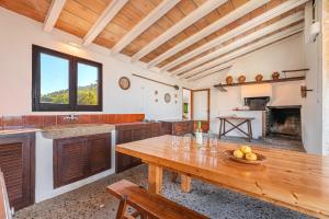 a kitchen with a wooden table with a bowl of fruit on it at Can Faveta in Alcudia