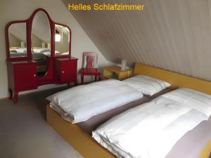 a bedroom with two beds and a mirror at Ferienwohnung Stine in Stetten