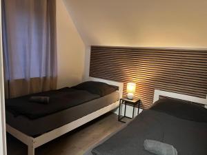 a bedroom with two beds and a window with a lamp at Wohnung mit Fernblick in Jübek