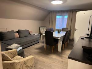 a living room with a table and a couch at Wohnung mit Fernblick in Jübek