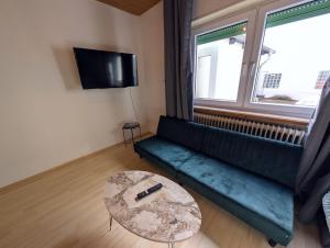 a living room with a couch and a table at Wat Bickenbach in Bickenbach