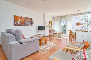 a living room with a couch and a table at Carabeo 19 in Nerja