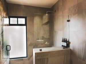 a bathroom with a shower with a tub and a sink at 7 Valles in Valle de Guadalupe +104 photos