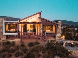 a house with a large deck on a mountain at 7 Valles in Valle de Guadalupe