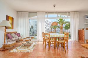 a living room with a table and chairs and a couch at Carabeo 19 in Nerja