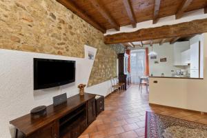 a living room with a flat screen tv on the wall at Casa Laura in Salò