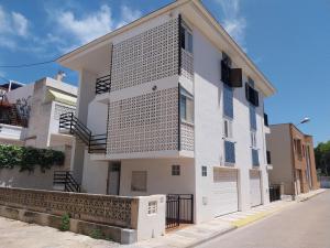 a white building with stairs on the side of it at Manhattan in Oliva