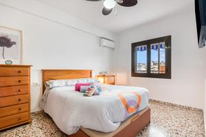 a bedroom with a bed and a dresser and a window at Manhattan in Oliva
