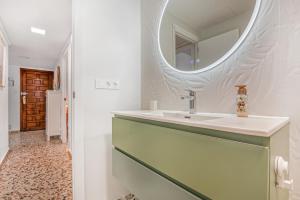 a bathroom with a sink and a mirror at Manhattan in Oliva +17 photos