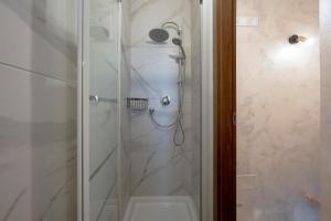 a bathroom with a shower with a glass door at Villa Marzla in Cassano delle Murge +15 photos